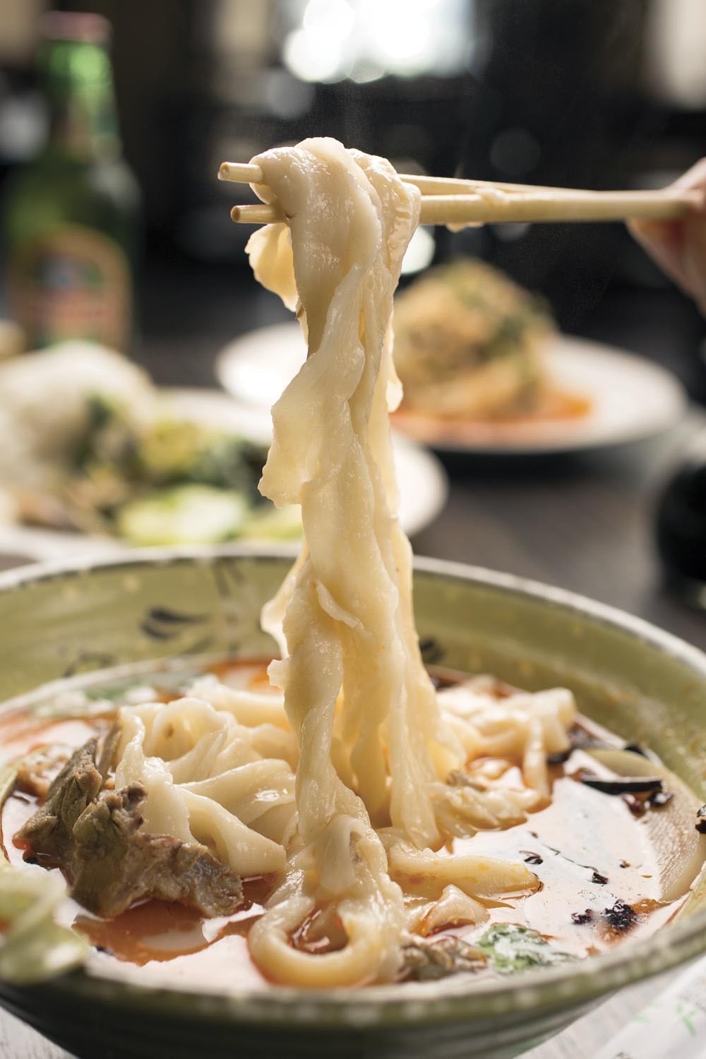 Hand-pulled noodles being stretched